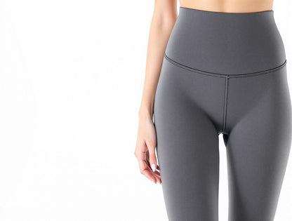 High-waisted compression leggings in sleek gray, perfect for stylish women's activewear and fitness fashion.