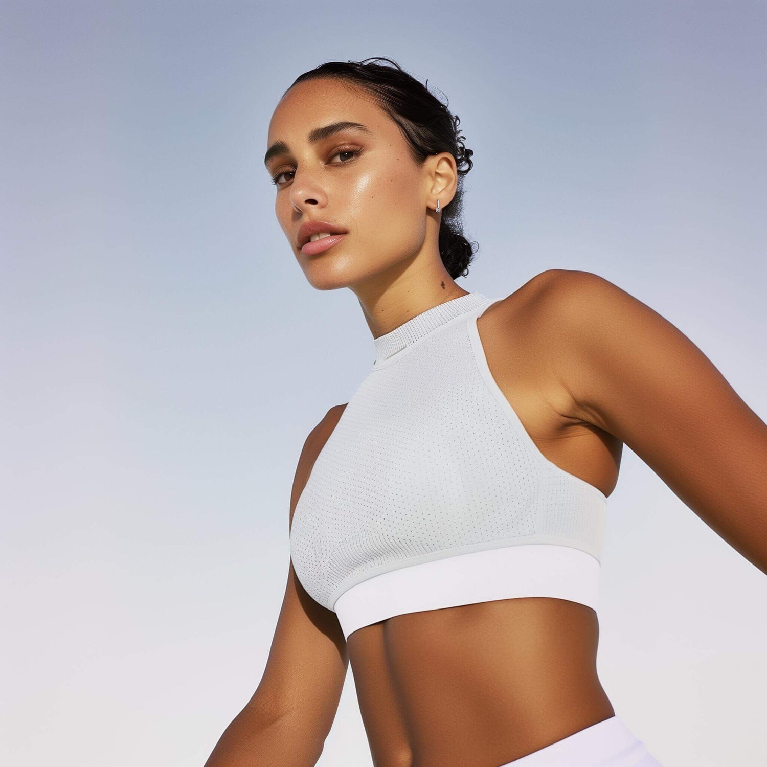 Woman in white athletic crop top for activewear inspiration
